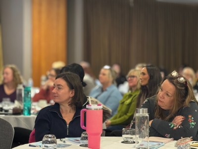 A group of people at a conference looking interested